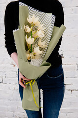 Bouquet of orchid flowers in pistachio-colored package
