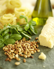 Ingredients for pesto sauce; pine nuts, basil, olive oil and tagliatelli