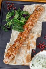Grilled kebab with pita bread, pomegranate and sauce