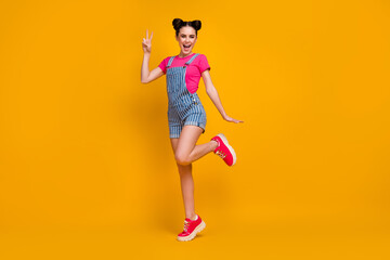 Fototapeta na wymiar Full length body size view of her she nice-looking attractive lovely cheerful cheery girl having fun showing v-sign isolated on bright vivid shine vibrant yellow color background