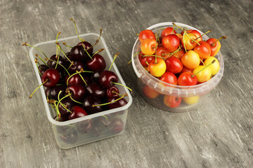 Cherries yellow pink and red in a plastic container