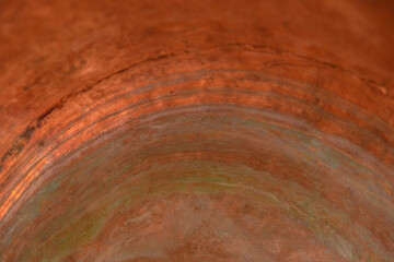 Copper surface of the inner part of the copper pot. Oxidation of copper. Copy space.