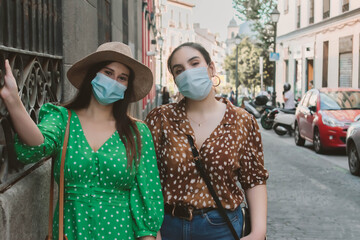 Fototapeta na wymiar Two female woman wearing mask in the new normal in the street