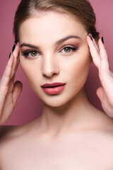 naked young woman with eye shadow and lipstick isolated on pink