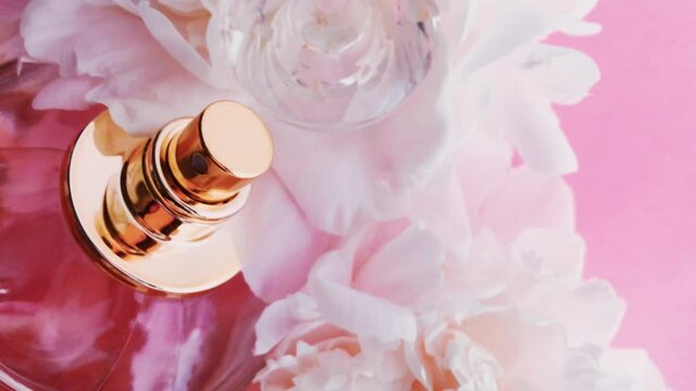 Pink perfume bottle with peony flowers, chic fragrance scent as luxury cosmetic, fashion and beauty product backgrounds
