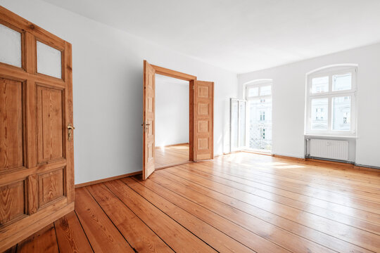 empty living room in apartment flat with wooden floor and balcony