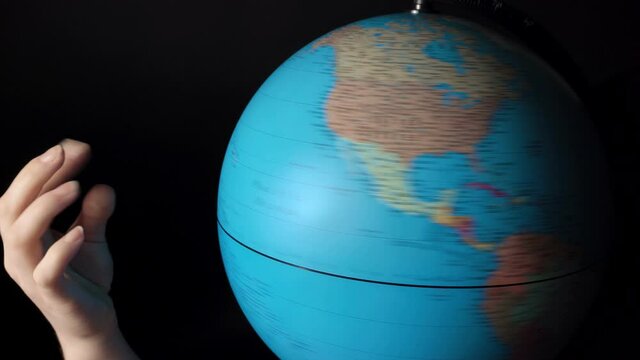 Video of rotating around blue globe with hand