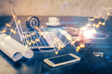 Stock market chart hologram drawn on personal computer background. Double exposure. Concept of investment.