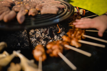 The chef grills meat and vegetables in the backyard