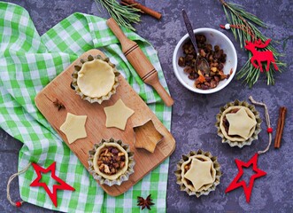 Step-by-step cooking of mince pies  traditional British Christmas shortcrust pastry cakes stuffed with dried fruits, nuts and apples.