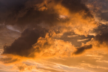 Fototapeta premium Dramatic orange clouds at sunset