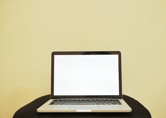 Laptop screen mockup with yellow background.