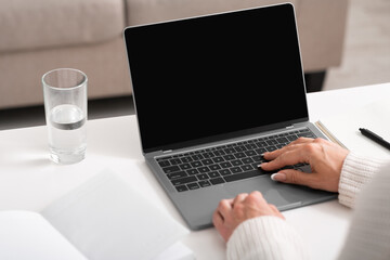 Businesswoman at work. Female hands typing on laptop on table