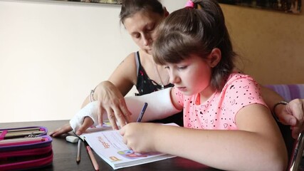 mom helps her daughter with homework