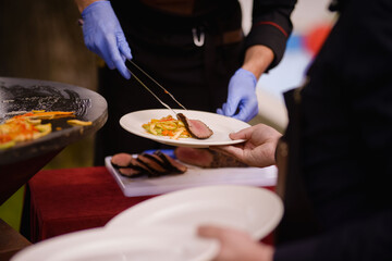 Obraz na płótnie Canvas The chef serves the dish on a plate. Steak topping