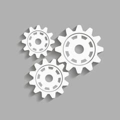 Mechanical gears with a shadow. Vector icon