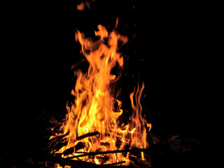 Fototapeta na wymiar bonfire on Ivan Kupala. bonfire with branches at night in the forest. tongues of fire. flames of fire. night fire 