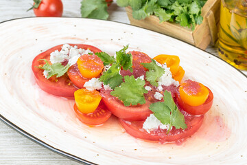 Salad of red and yellow tomatoes with fresh herbs
