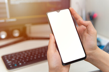 person holding phone in hand and blank smart phone screen