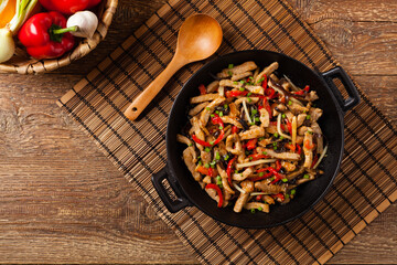 Pork chop with peppers, mushrooms and bamboo. Served with rice.