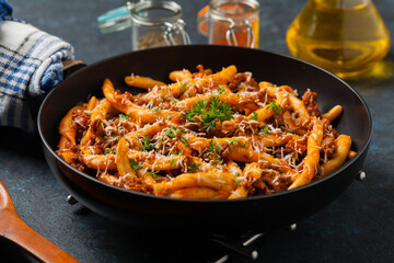 Maccheroni al ferretto with beef in ragu bolognese. Front view.