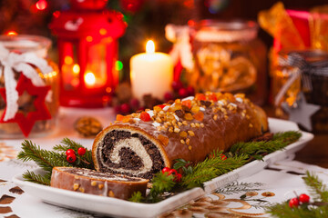 Poppy seed roulade in Christmas decoration. Served with coffee or tea.