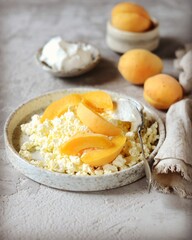 Fresh homemade cottage cheese with sour cream and apricots, breakfast, still life