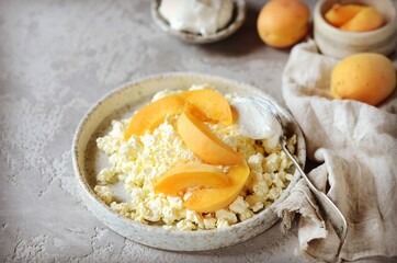 Fresh homemade cottage cheese with sour cream and apricots, breakfast, still life