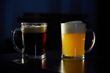 two mugs of dark and light beer on the bar. International beer day. Culture of brewing in a craft beer store