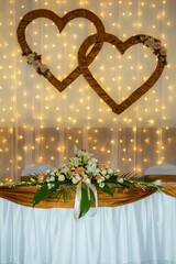 Beautiful golden brown and white decoration for wedding ceremony or banquet decoration. On the table is a bright flower vase with beautiful crystal flowers and a bouquet of flowers. 