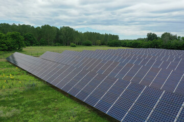 Renewable solar power plant. Aerial view as solar energy is converted by solar cells into...