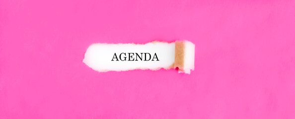 The text AGENDA appearing behind torn pink paper.