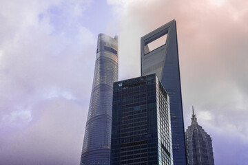 Modern skyscrapers in Lujiazui, the financial district in Shanghai, shot on a cloudy day, at sunset.