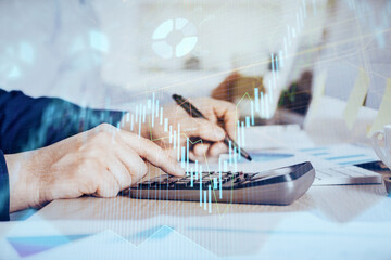 Financial trading graph multi exposure with man desktop background.
