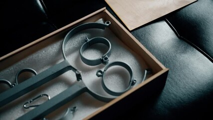 BDSM stocks and metal fasteners in box