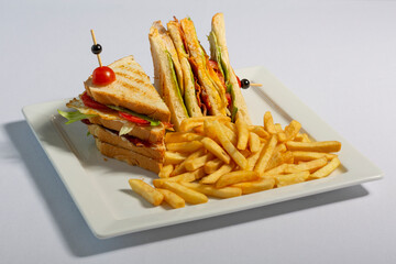 Club sandwich served with french fries