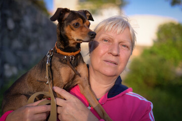 Aged woman with her dog.
