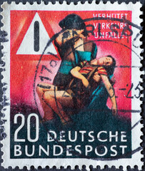 Preventing traffic accidents is the motto of this postal stamp. You can see a mother holding her...