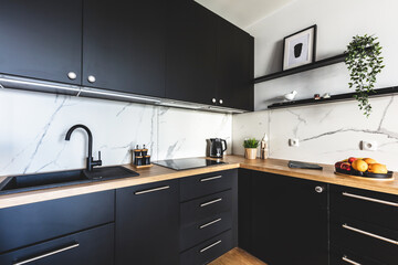 Kitchen in a modern studio apartment for rent. Interior design.