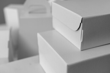 Different design and shape of cardboard boxes, paper containers. The concept of production and development of packaging. Industry. Place for text. Black and white