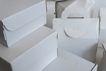 Different design and shape of cardboard boxes, paper containers. The concept of production and development of packaging. Industry. Place for text
