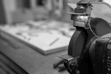 Selective focus. Copy space. Whetstone, workshop mechanics, carpenter. Handmade concept. Repair and manufacturing of parts. Black and white