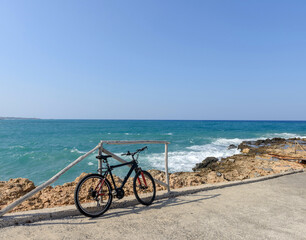 Fototapeta premium Bicycle parked near the sea standing on the beach. Greece. Велосипед на берегу моря. Bicycle