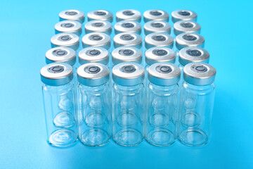 angle view empty vaccine bottles on blue background