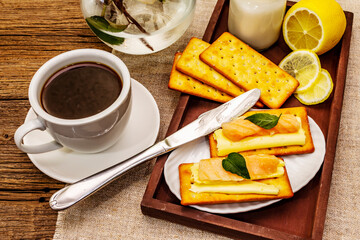 Healthy breakfast. Cup of coffee (black tea), milk, crackers with butter and salmon
