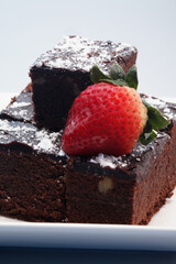 Brownies with icing sugar and strawberry