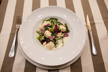 Served delicious food in the restaurant, salads, dishes, meat, sauces. 
