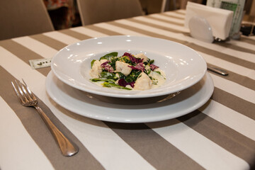 Served delicious food in the restaurant, salads, dishes, meat, sauces. 
