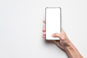 Man uses touchscreen mobile phone devices with isolated blank white screen. Template for marketing...