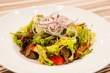 Served delicious food in the restaurant, salads, dishes, meat, sauces. 
